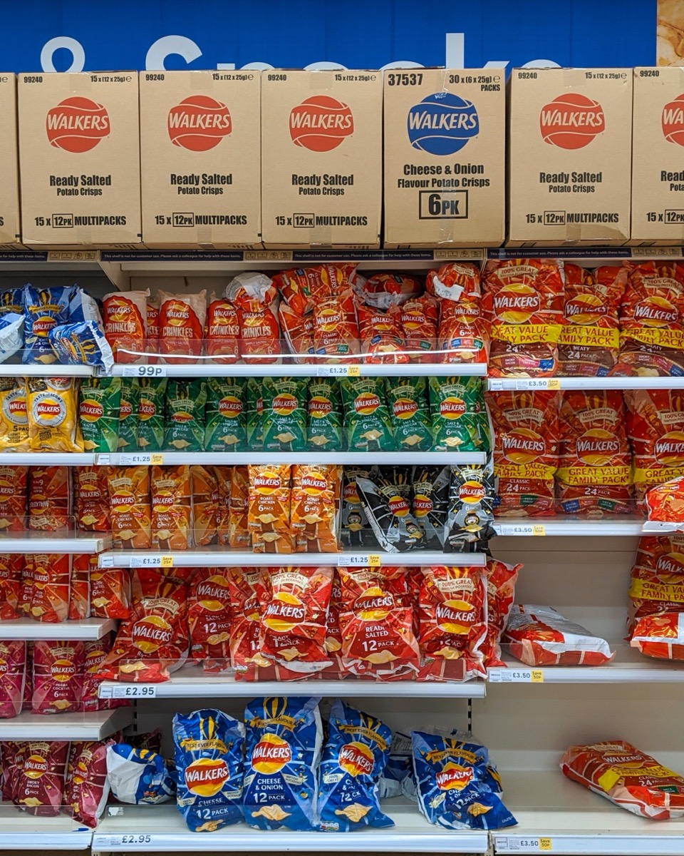 A Tesco crisp aisle packed with Walkers multipacks
